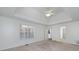 This light-filled bedroom includes neutral carpet, a tray ceiling, and bright windows at 249 Edenwylde Ct, Hampton, GA 30228