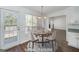 Bright dining area features new floors, updated lighting, and large window views of the outdoor deck and pool at 249 Edenwylde Ct, Hampton, GA 30228