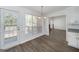 Bright dining area features new floors, updated lighting, and large window views of the outdoor deck and pool at 249 Edenwylde Ct, Hampton, GA 30228