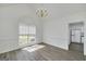 Dining area with a view, luxury vinyl floors, and a chandelier at 249 Edenwylde Ct, Hampton, GA 30228