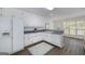 Bright kitchen featuring white cabinets, vintage hardware and stainless-steel appliances at 249 Edenwylde Ct, Hampton, GA 30228