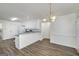 Open-concept kitchen boasts white cabinetry, modern appliances, and breakfast bar for casual dining and entertaining at 249 Edenwylde Ct, Hampton, GA 30228