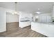 Open-concept kitchen boasts white cabinetry, modern appliances, and breakfast bar for casual dining and entertaining at 249 Edenwylde Ct, Hampton, GA 30228