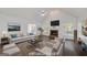 Staged living room featuring a vaulted ceiling, brick fireplace, and hardwood flooring at 249 Edenwylde Ct, Hampton, GA 30228