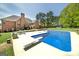 Backyard oasis featuring an in-ground pool, ample patio space, and lush landscaping perfect for outdoor entertaining at 249 Edenwylde Ct, Hampton, GA 30228
