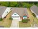Aerial view showcases landscaped front yard of a house with an attached garage at 161 Spring Creek Blvd, Mcdonough, GA 30253