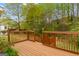 Wooden back deck with steps leading to the lawn and backyard wooded area at 161 Spring Creek Blvd, Mcdonough, GA 30253