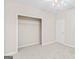Beige bedroom featuring a closet and white door to enhance space and style at 161 Spring Creek Blvd, Mcdonough, GA 30253