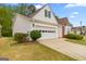 A side exterior view of the home showcasing the driveway, lawn and one-car garage at 161 Spring Creek Blvd, Mcdonough, GA 30253