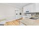 Well-lit kitchen with stainless appliances, granite countertops and hardwood flooring at 161 Spring Creek Blvd, Mcdonough, GA 30253