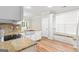 Modern kitchen boasts granite countertops, a farm sink, and a stylish backsplash at 161 Spring Creek Blvd, Mcdonough, GA 30253