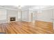 Bright living room features a charming fireplace, hardwood floors, and a ceiling fan at 161 Spring Creek Blvd, Mcdonough, GA 30253