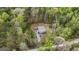 Aerial view of the home surrounded by mature trees and a long driveway at 803 Bentley Hill Rd, Stockbridge, GA 30281