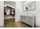 Open bathroom featuring a sleek vanity, modern sink, and a spacious walk-in closet at 803 Bentley Hill Rd, Stockbridge, GA 30281