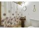 Cozy bathroom featuring a unique copper sink, a toilet, and a floral shower curtain at 803 Bentley Hill Rd, Stockbridge, GA 30281