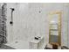 Bright bathroom featuring a marble-tiled shower with a bench and a decorative gold mirror at 803 Bentley Hill Rd, Stockbridge, GA 30281