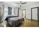 Bright bedroom boasts natural light from a large window and a stylish ceiling fan at 803 Bentley Hill Rd, Stockbridge, GA 30281