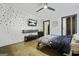 Modern bedroom featuring unique wall decor, a mounted TV, and stylish furnishings at 803 Bentley Hill Rd, Stockbridge, GA 30281