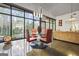 Dining area with a modern glass table set, concrete floors, and large picture windows at 803 Bentley Hill Rd, Stockbridge, GA 30281