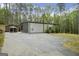 Modern home exterior featuring a large concrete driveway and additional gazebo structure at 803 Bentley Hill Rd, Stockbridge, GA 30281