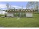 A modern single-story home, with walls of windows, surrounded by a green lawn at 803 Bentley Hill Rd, Stockbridge, GA 30281