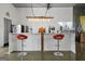 Stylish bar features a white countertop, red stools, and ample lighting, perfect for entertaining at 803 Bentley Hill Rd, Stockbridge, GA 30281