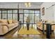 Living area featuring beige couches, large windows, concrete floors, and modern decor at 803 Bentley Hill Rd, Stockbridge, GA 30281