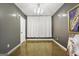 A simple room with neutral walls, concrete flooring, a chandelier, and modern art at 803 Bentley Hill Rd, Stockbridge, GA 30281