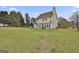 Lush backyard showcasing a manicured lawn and home exterior with a deck and patio, ideal for outdoor gatherings at 198 Crestwood Rd, Tyrone, GA 30290