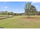 Wide shot of backyard that showcases the expansive green space and shed at 198 Crestwood Rd, Tyrone, GA 30290