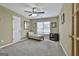 Cozy bedroom with a ceiling fan, neutral walls, carpet, and a small seating area by the window at 198 Crestwood Rd, Tyrone, GA 30290