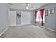 Bright bedroom with neutral walls, plush carpet, and a large window with red curtains allowing ample natural light at 198 Crestwood Rd, Tyrone, GA 30290