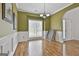 Bright dining room with wainscoting, modern light fixture, and large window at 198 Crestwood Rd, Tyrone, GA 30290