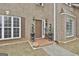 Stylish brown front door with elegant topiary plants and brick porch at 198 Crestwood Rd, Tyrone, GA 30290