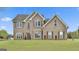 Two-story brick home featuring manicured lawn and multiple double hung windows at 198 Crestwood Rd, Tyrone, GA 30290