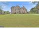 Two-story brick home on a grassy lot beneath a partly cloudy sky at 198 Crestwood Rd, Tyrone, GA 30290
