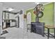 Bright kitchen with white cabinets, stainless steel appliances, and green accent wall with vintage decor at 198 Crestwood Rd, Tyrone, GA 30290