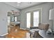 Comfortable living room showing chair, wood floors, and arched doorway to bedroom at 198 Crestwood Rd, Tyrone, GA 30290