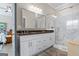 Modern bathroom featuring a double vanity, granite countertops, and a glass-enclosed shower with marble tiling at 5124 N Pratt St, Covington, GA 30014