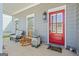 Charming front porch with seating area, a red door, and decorative accents at 5124 N Pratt St, Covington, GA 30014