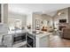 Open-concept kitchen with an island, modern appliances, and a view of the dining and living areas at 5124 N Pratt St, Covington, GA 30014
