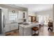 Bright kitchen with modern appliances, a granite countertop, and view of the dining area at 5124 N Pratt St, Covington, GA 30014