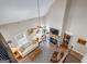 Open concept living room with high ceilings, a brick fireplace, and large windows providing ample natural light at 5124 N Pratt St, Covington, GA 30014
