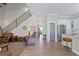 Inviting living room with hardwood floors, staircase, and view of the kitchen at 5124 N Pratt St, Covington, GA 30014