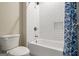 Close-up of bathtub and shower featuring white subway tile and a blue patterned shower curtain and brushed nickel fixtures at 5124 N Pratt St, Covington, GA 30014