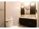 Modern bathroom featuring double sinks, a large mirror, and dark cabinets at 702 Las Brasis Ct, Peachtree City, GA 30269