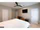 Inviting bedroom featuring ceiling fan, carpet, and TV mounted to the wall at 702 Las Brasis Ct, Peachtree City, GA 30269