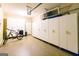 Spacious garage features ample cabinet storage for organization and accessibility at 702 Las Brasis Ct, Peachtree City, GA 30269