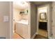 Bright laundry room with modern appliances and convenient access to the bathroom at 702 Las Brasis Ct, Peachtree City, GA 30269