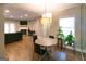 Living room features a modern table, light fixture, fireplace, and laminate floors at 702 Las Brasis Ct, Peachtree City, GA 30269
